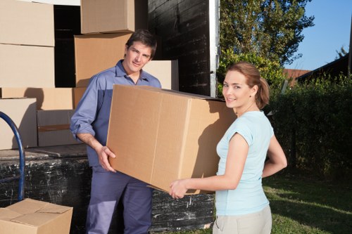 Specialist movers carrying a valuable furniture piece in Mayfair